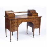 An Edwardian satinwood and marquerty inlaid desk with a leather inset top seven drawers, square
