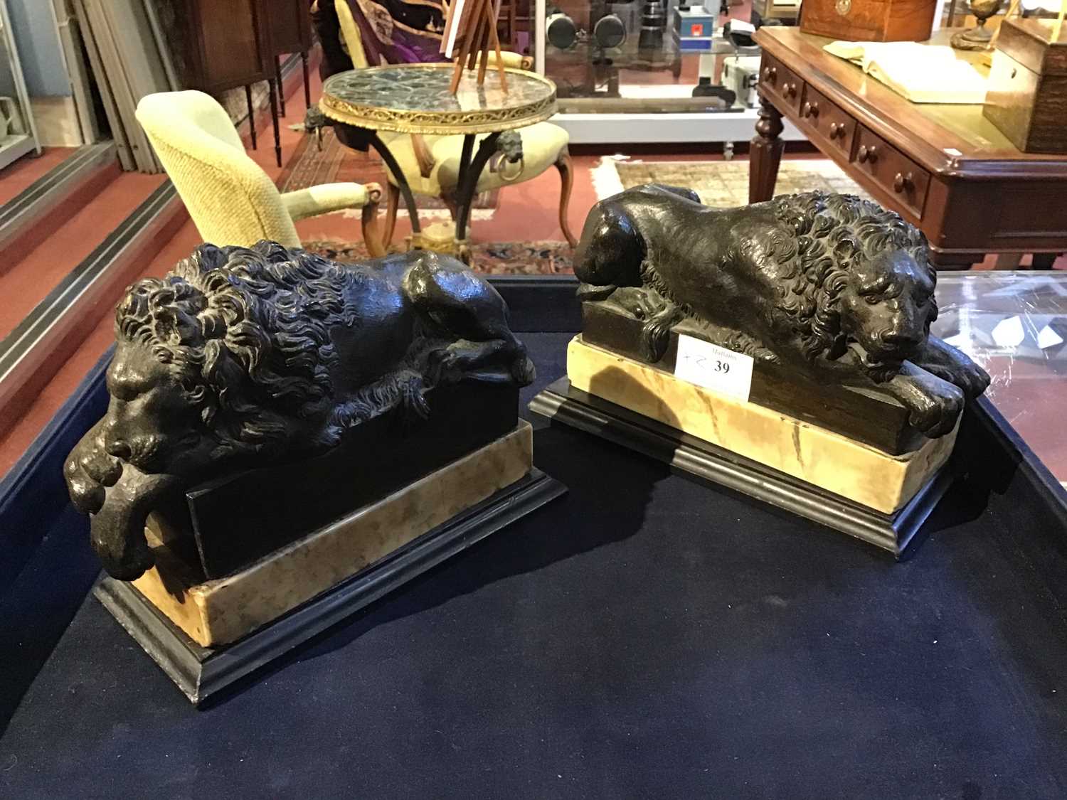 A pair of early 19th century Grand Tour bronze recumbent lions each mounted on white marble bases, - Image 9 of 10