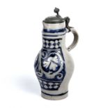 An 18th century Westerwald stoneware jug with a pewter cover, 18cm wide x 38cm high