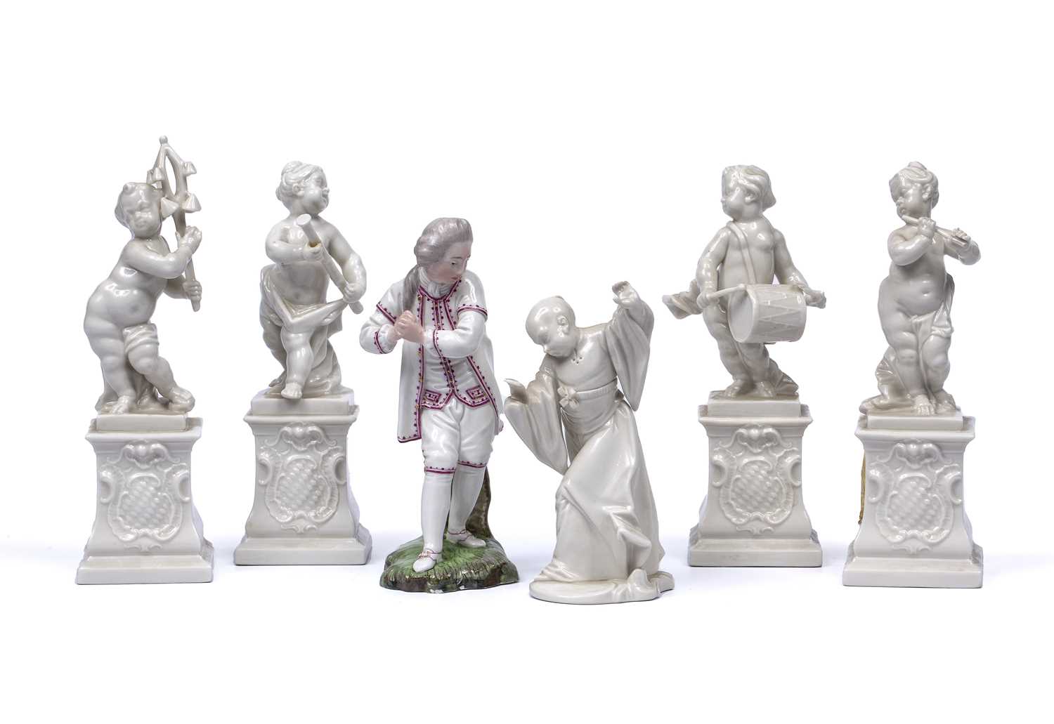 A group of four Nyphemburg porcelain cherub band figures 17cm high a Nymphenburg easten figure, no