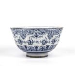 An antique Dutch delft punch bowl with blue scrolling foliate decoration 30cm diameter 6.5cm high.