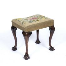 A George III style mahogany stool with a needlework top, cabriole legs, and claw and ball feet, 50cm