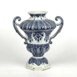 An 18th century French Rouen Faience blue and white vasiform urn with foliate decoration, 25cm