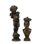 An antique bronze cherub, 10.5cm in height and a bronze portrait bust of a crowned boy, 7cm in
