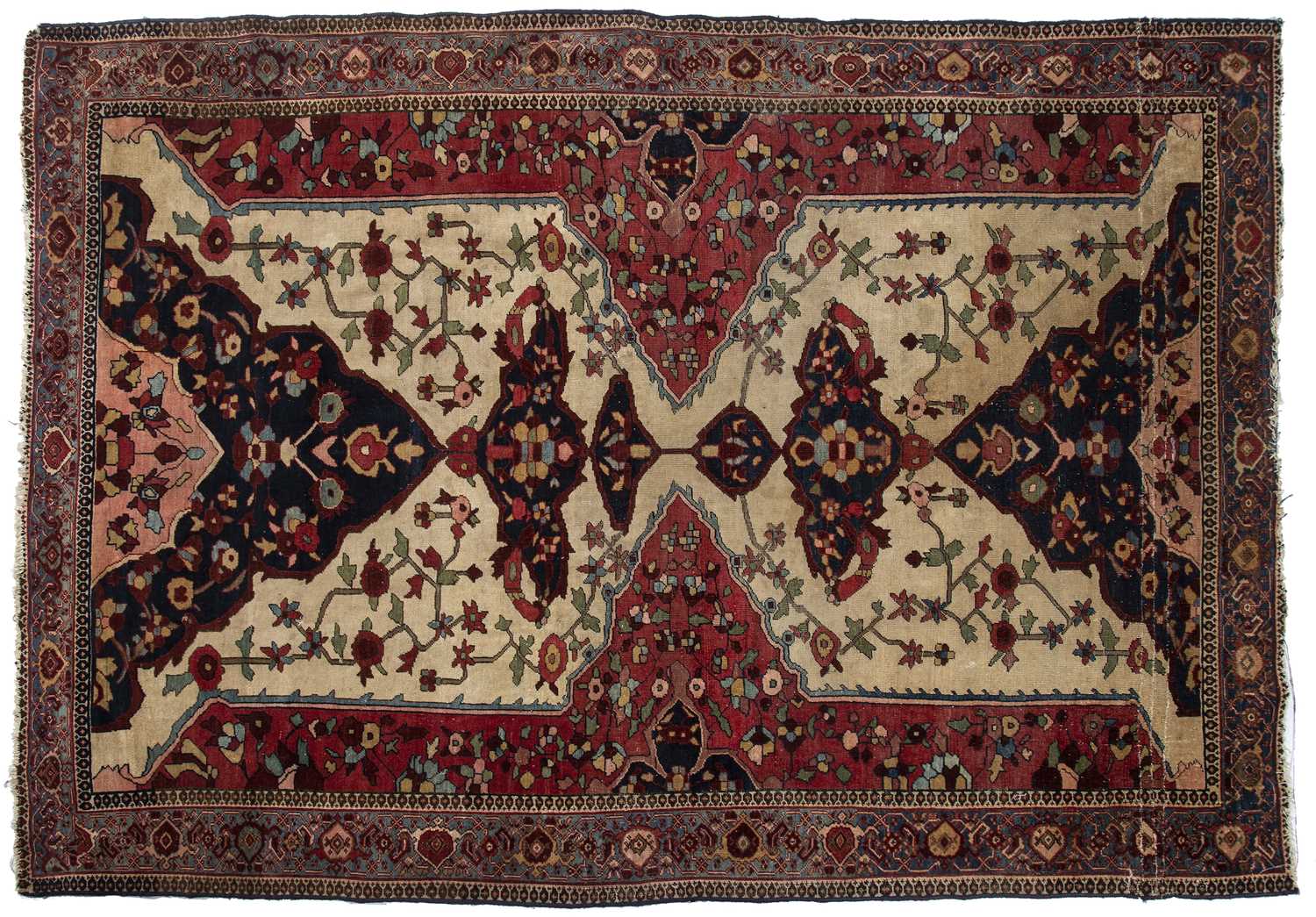 An early 20th century Middle Eastern red and blue ground rug with geometric foliate decoration.