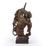 A late 18th/19th century carved elm Unicorn, mounted on a lead base, 23cm wide x 50cm highLater