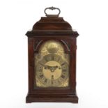 An early 18th century walnut bracket or table clock, the 6 3/4" break arch brass dial with Roman