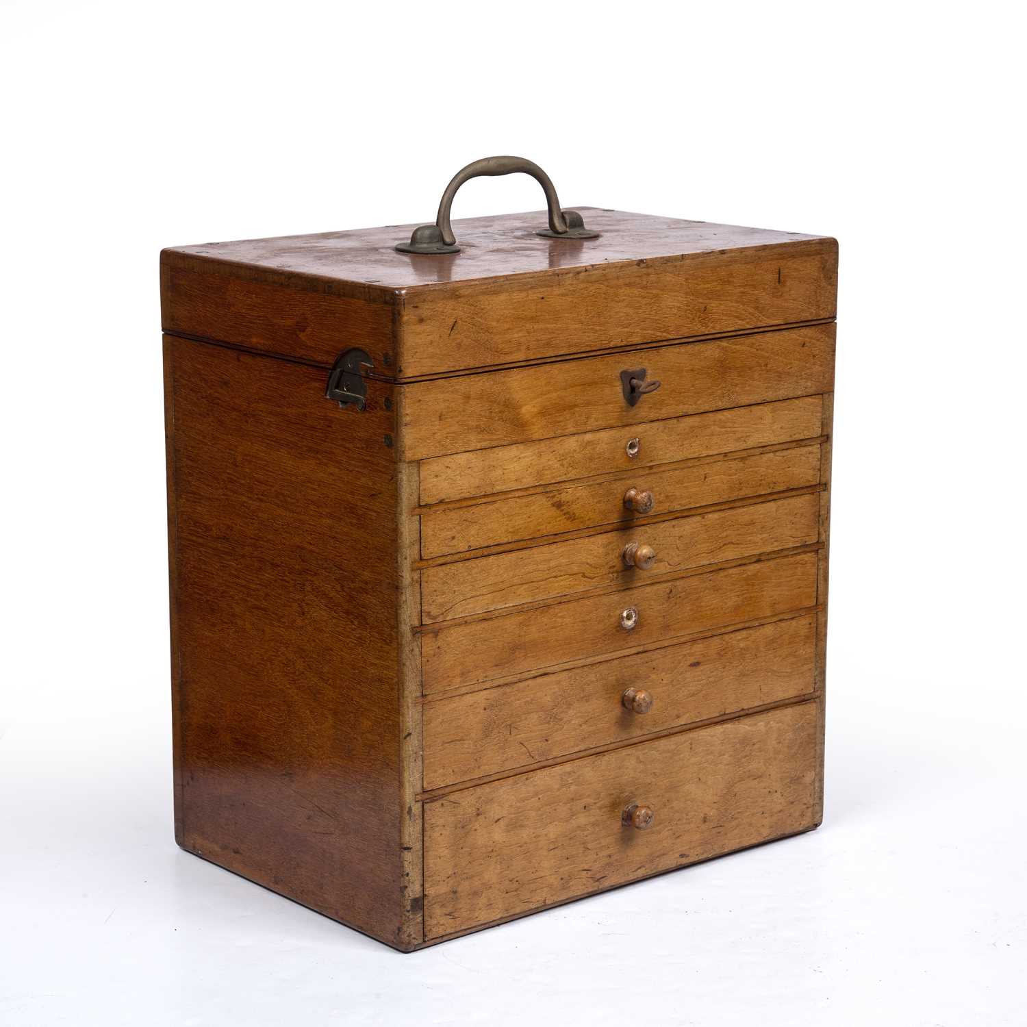 An early 20th century mahogany medical cabinet with a brass carrying handle, lifting top and six