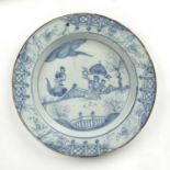 An 18th century English delft ware charger with tin glazed blue and white decoration, in the Chinese