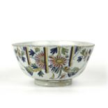 An 18th century English delft punch bowl, possibly Bristol, with polychrome floral decoration,