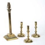 Three early 18th century English brass candlesticks the largest 17cm in height together with a