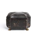 A George III lacquered tea caddy of shaped octagonal form, original lead interior and paw feet, 20cm