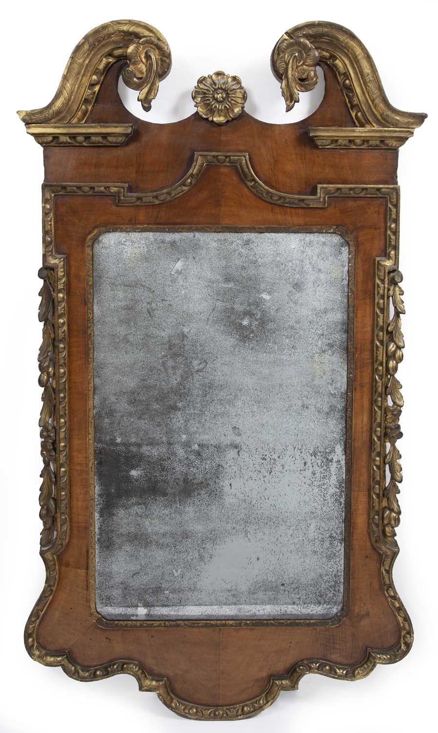 A George II walnut and parcel gilt wall mirror with original glass 70cm wide 123cm high.Been re-