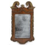 A George II walnut and parcel gilt wall mirror with original glass 70cm wide 123cm high.Been re-