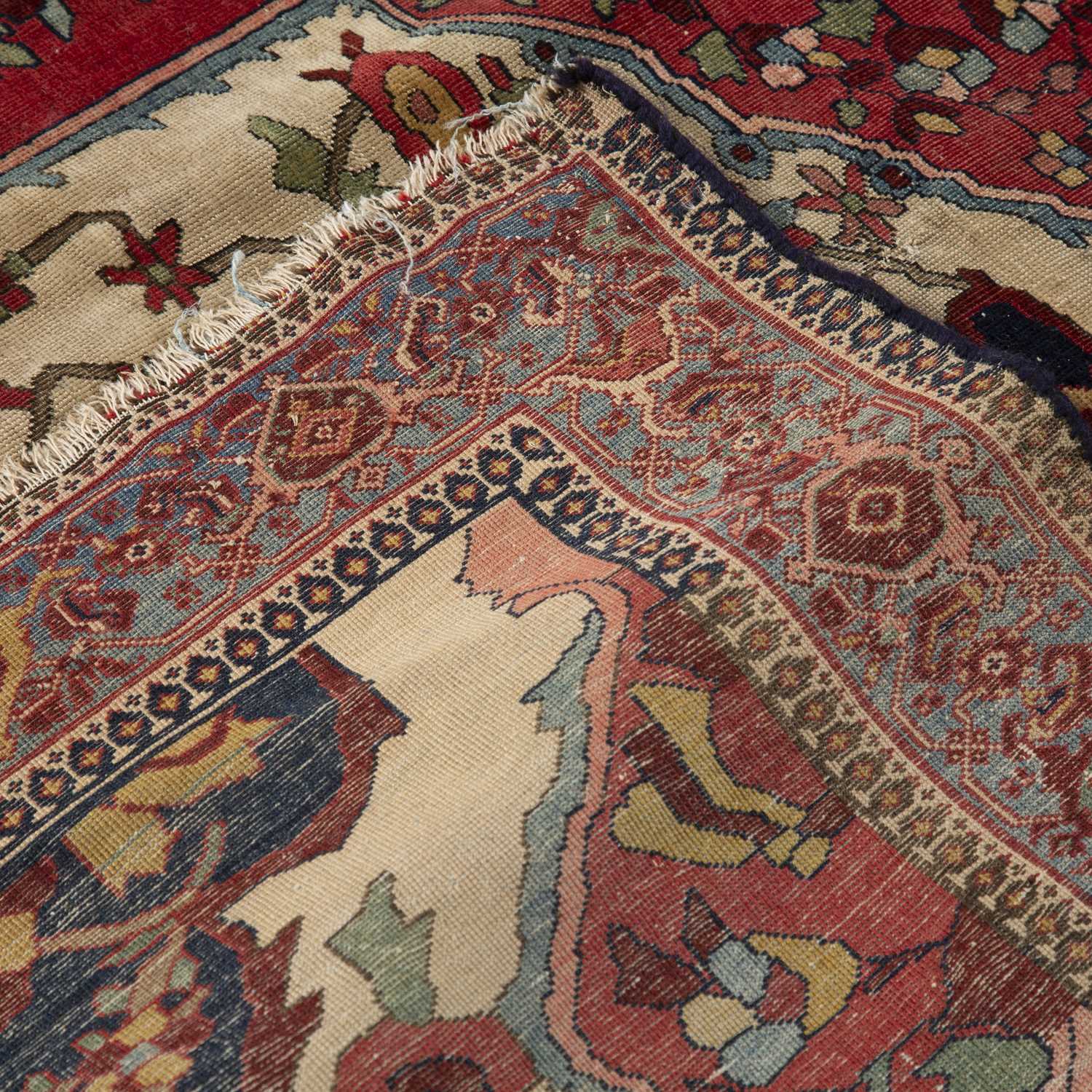 An early 20th century Middle Eastern red and blue ground rug with geometric foliate decoration. - Image 3 of 4