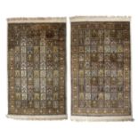 A pair of Indian cream ground silk rugs with foliate decoration, 121cm x 200cmsome surface wear no