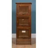 An early 20th century oak and hardwood three drawer filing cabinet