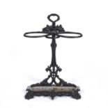 A Victorian black painted cast iron stick stand together with a collection of brass fire irons