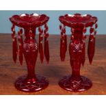 A pair of ruby glass lustres