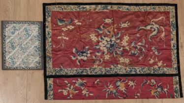 Two Chinese embroidered silks with floral decorations, one on a red ground with a black border,