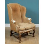 An 18th or 19th century mahogany framed wingback armchair
