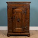 An antique Continental oak cupboard