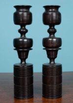 A pair of decorative turned ebony candlesticks