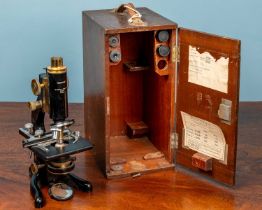 A W Watson & Sons monocular microscope and an adjustable slide clamp by J Swift & Son London