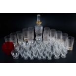 A set of twelve cut glass whisky tumblers together with a similar decanter; together with a set of g