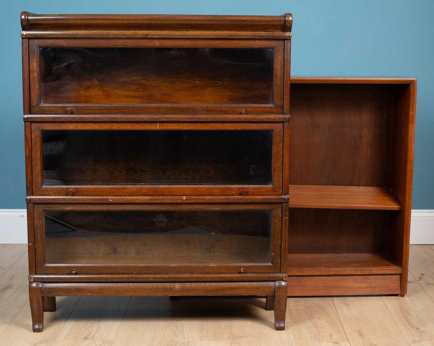 A Globe Wernicke stacking bookcase together with a Herbert E Gibbs teak open bookcase