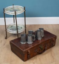 A suitcase, a drinks trolley, and pewter tankards