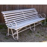 A Victorian white painted garden bench with wrought iron ends
