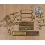 A collection of brass letterbox flaps, door handles and lockplates
