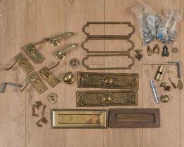 A collection of brass letterbox flaps, door handles and lockplates