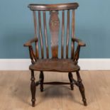 An antique ash and elm Windsor armchair with splat pierced with initials 'IB'
