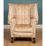 A Georgian style wing back armchair