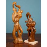 Two wooden abstract sculptures depicting figures dancing