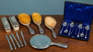 A silver backed dressing table mirror together with five various silver backed brushes and other sil