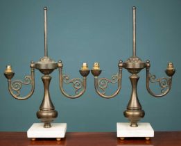 A pair of French Empire style brass lamps