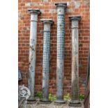 A group of four heavy cast iron columns