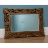 A decorative cushion framed gold painted rectangular wall mirror