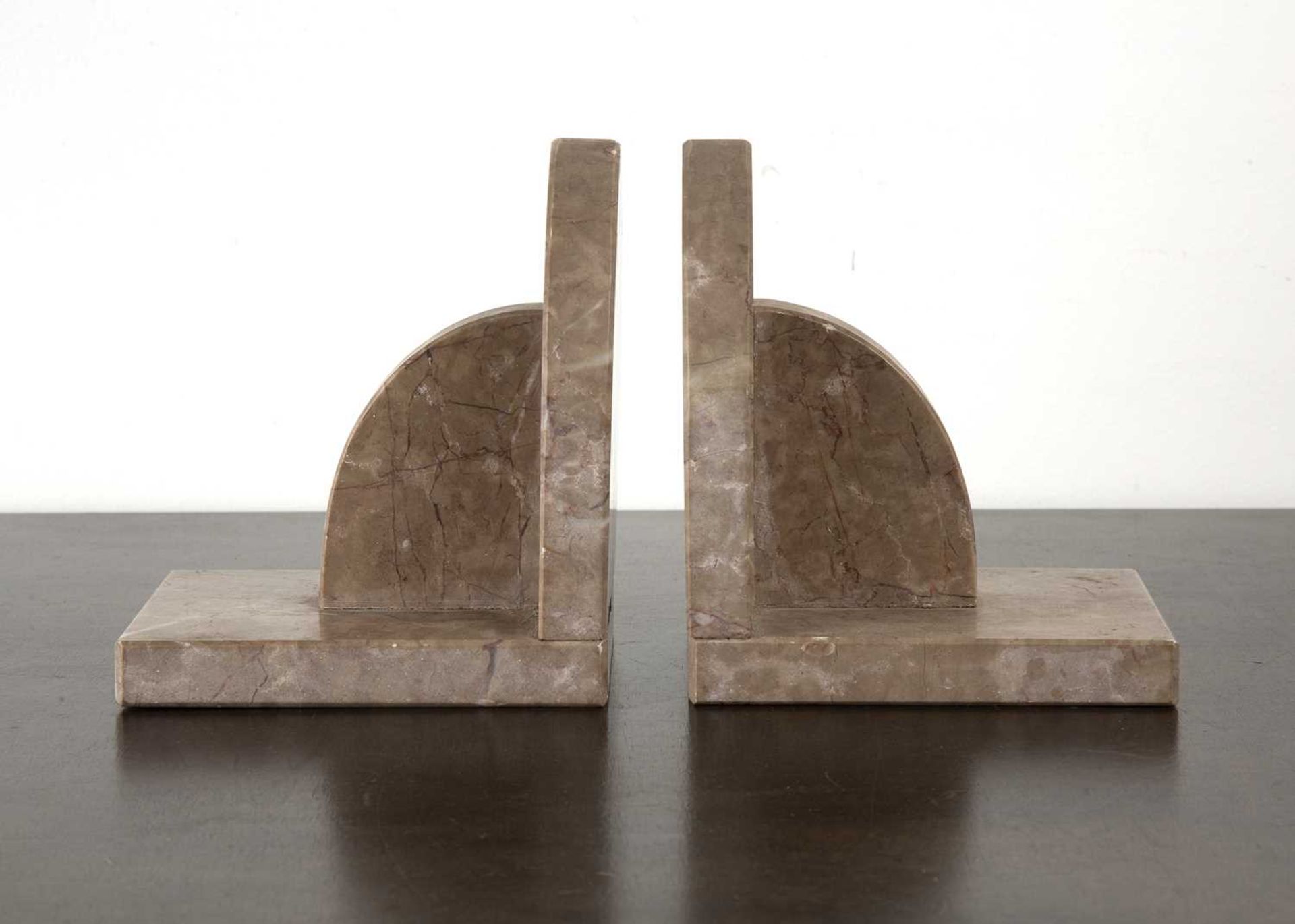 Pair of Art Deco marble bookends with arched decoration, unmarked, 16cm high x 13.5cm deep each (2)