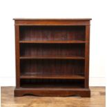 Oak open front bookcase with three height adjustable shelves flanked by reeded effect columns on