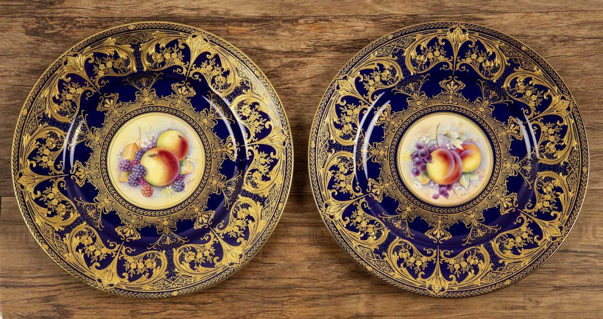 Pair of Royal Worcester porcelain cabinet plates the central panels with still life of fruit, signed
