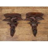 Pair of carved eagle wall brackets stained wood, with additional carved fruit decoration,36.5cm wide