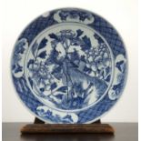 Blue and white porcelain charger Chinese, 19th Century, painted with a phoenix, 33.75cm diameterWith