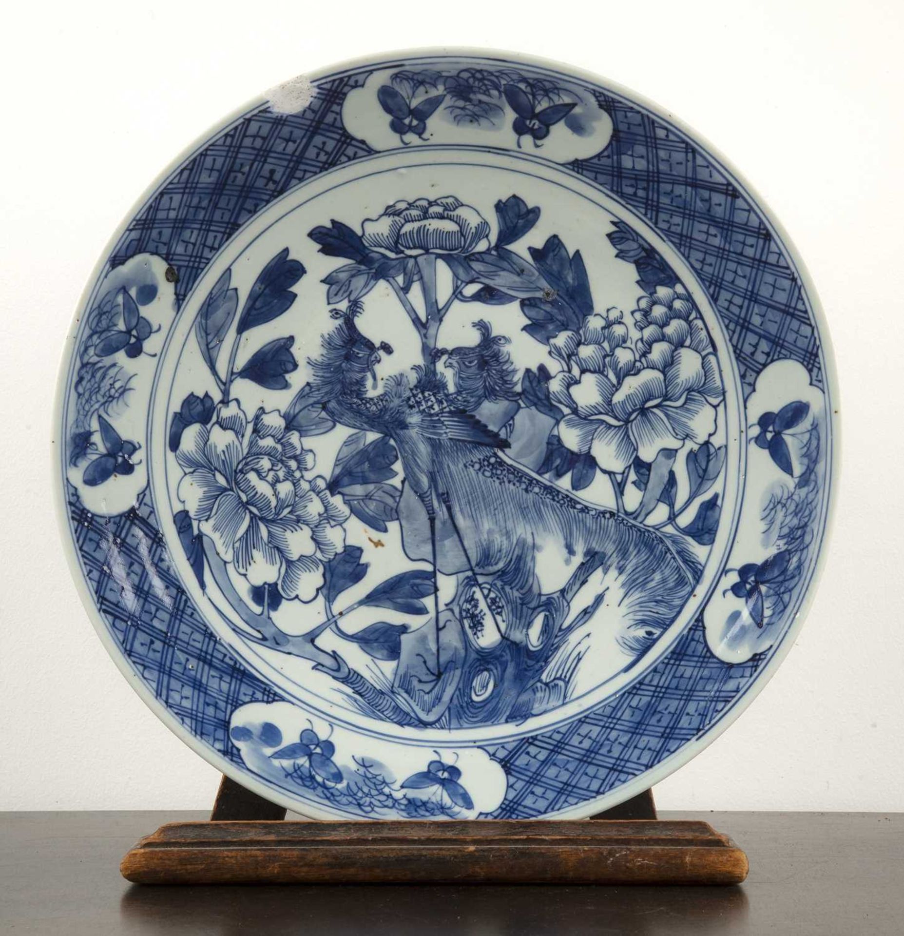 Blue and white porcelain charger Chinese, 19th Century, painted with a phoenix, 33.75cm diameterWith