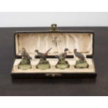 Set of four cold painted menu/name holders in the form of game birds probably Austrian, in the