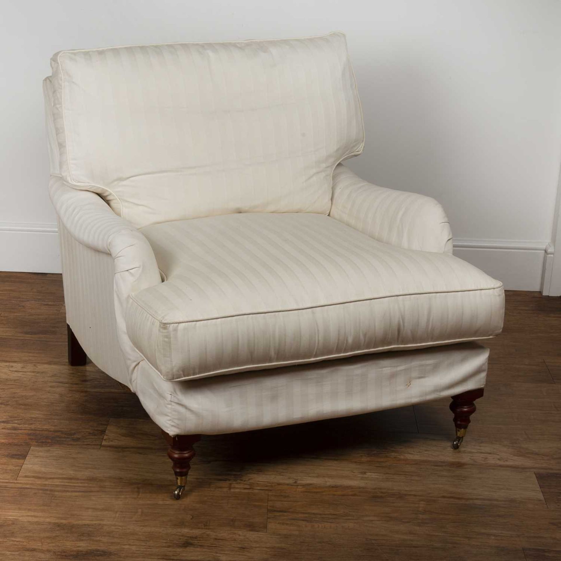 Howard style armchair Contemporary, with white striped upholstery, on brass castors, 86cm wide
