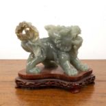 Carved jade model of a dog of fo Chinese, in the Ming style on a wood base, 16cm long x10.5cm high